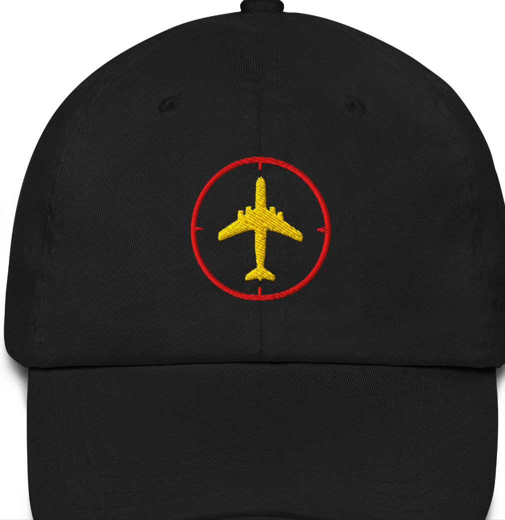 Baseball hat with an embroidered jumbo jet an outline of a compass