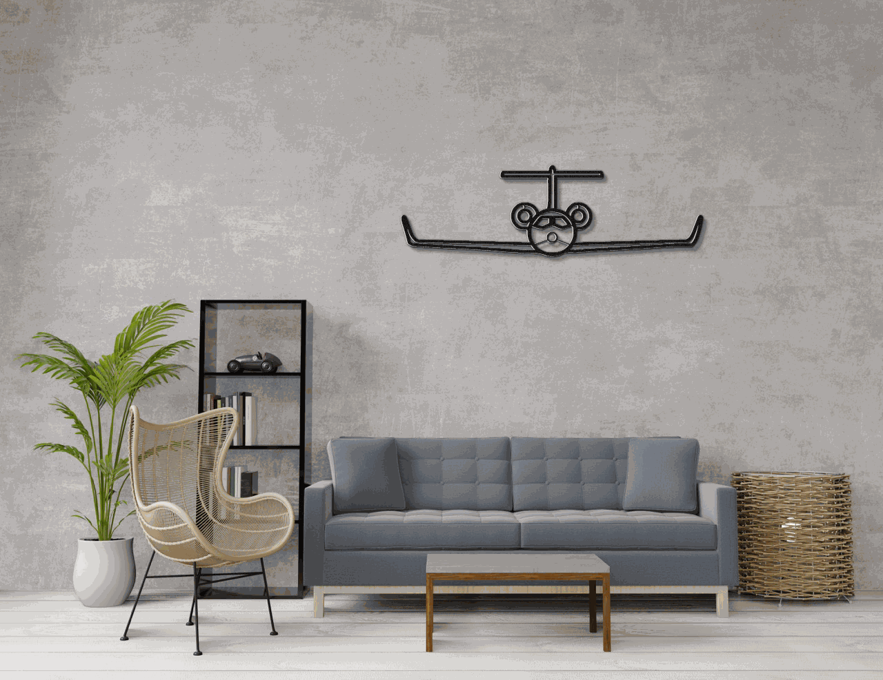 Modern living room with gray sofa, wicker chair, plant, and metal wall art aviation silhouette above sofa
