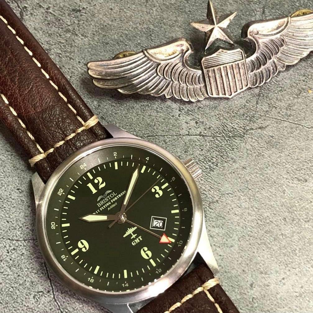 B-17 Tribute watch with stainless brush finish, dark green dial, and brown leather band with stitching