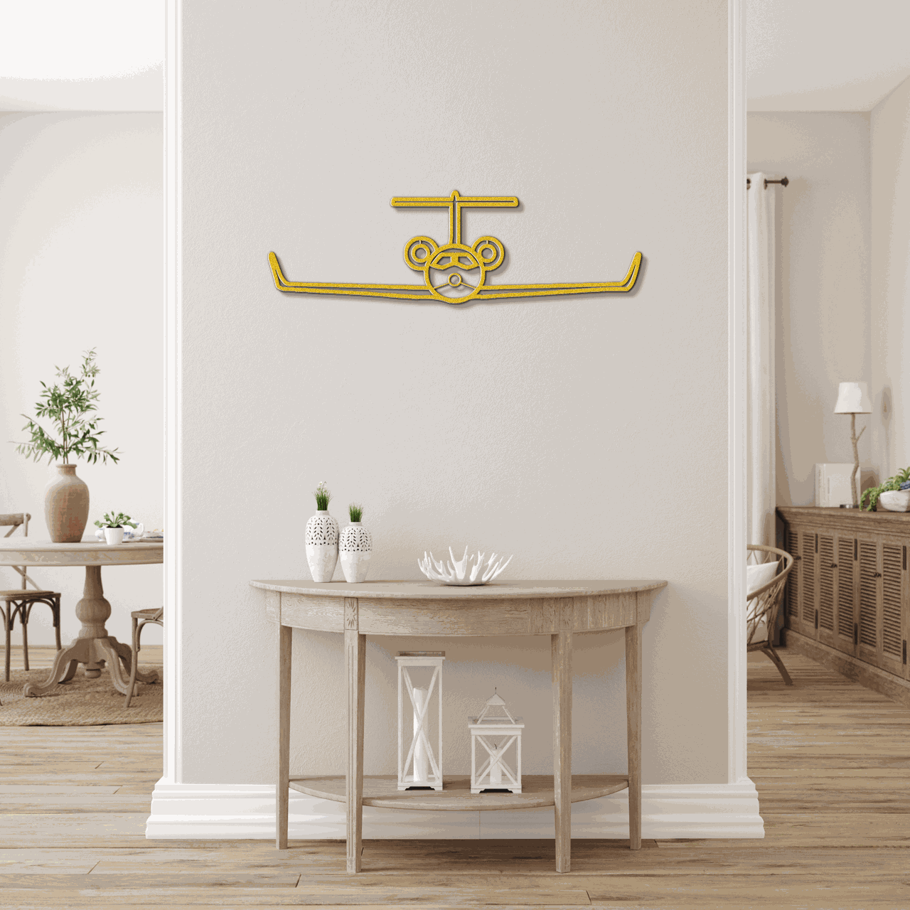 Gold metal wall art airplane silhouette mounted on beige wall above wooden console table in modern living room