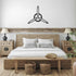 Elegant metal 3-blade prop sign wall decor in bedroom with rustic wooden furniture