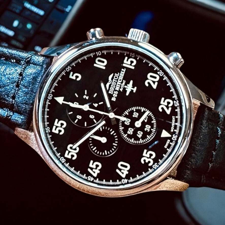 B-25 pilot watch with stainless steel case, black leather strap, and chronograph dial for aviation enthusiasts