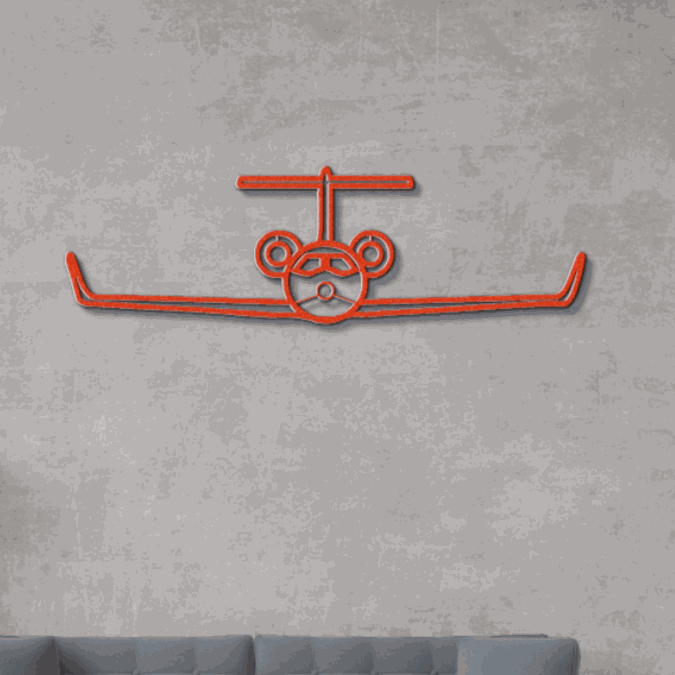 Red metal wall art aviation silhouette on gray wall above couch
