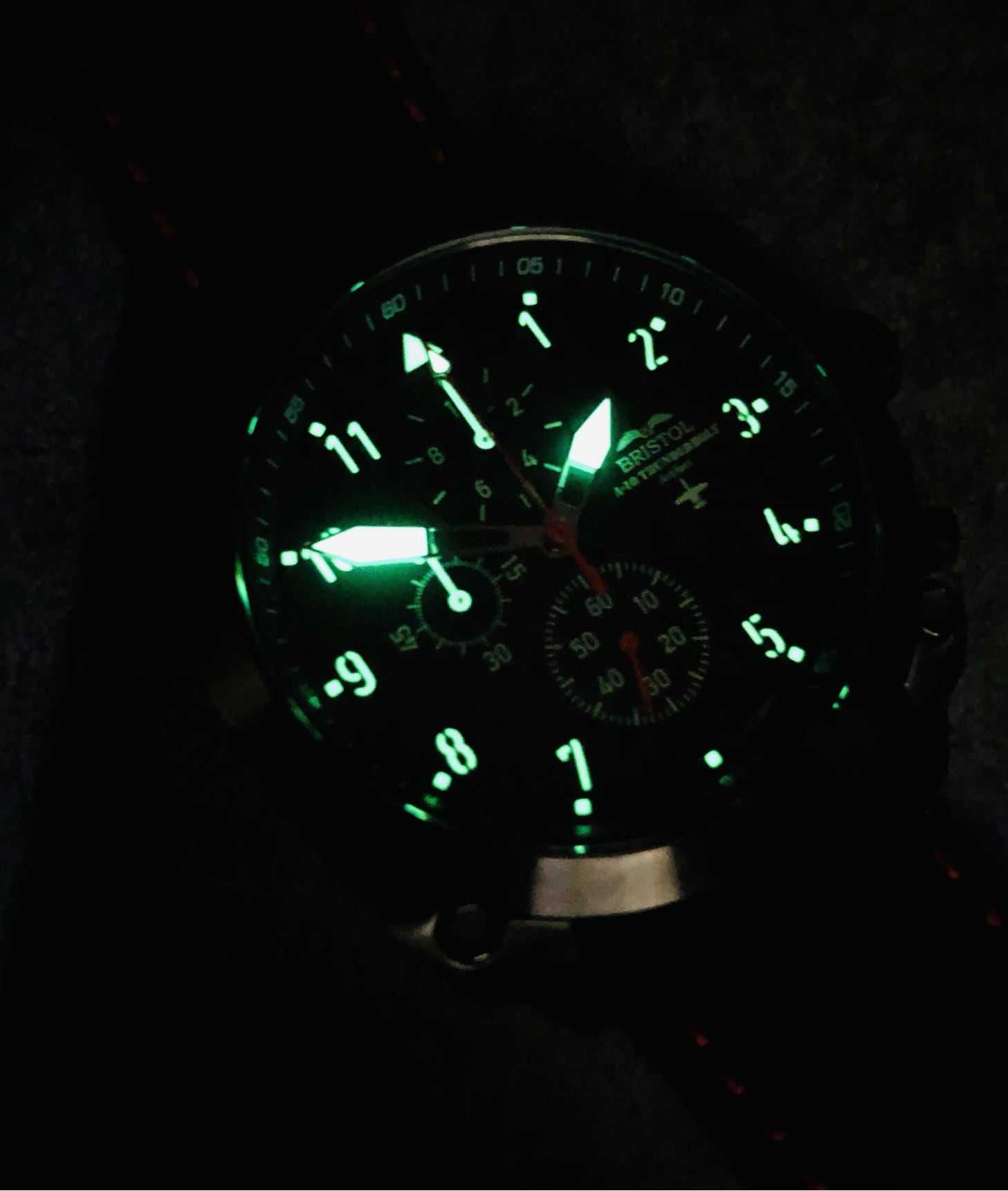 A-10 Thunderbolt watch with glowing Super Luminova dial and black leather band in low light