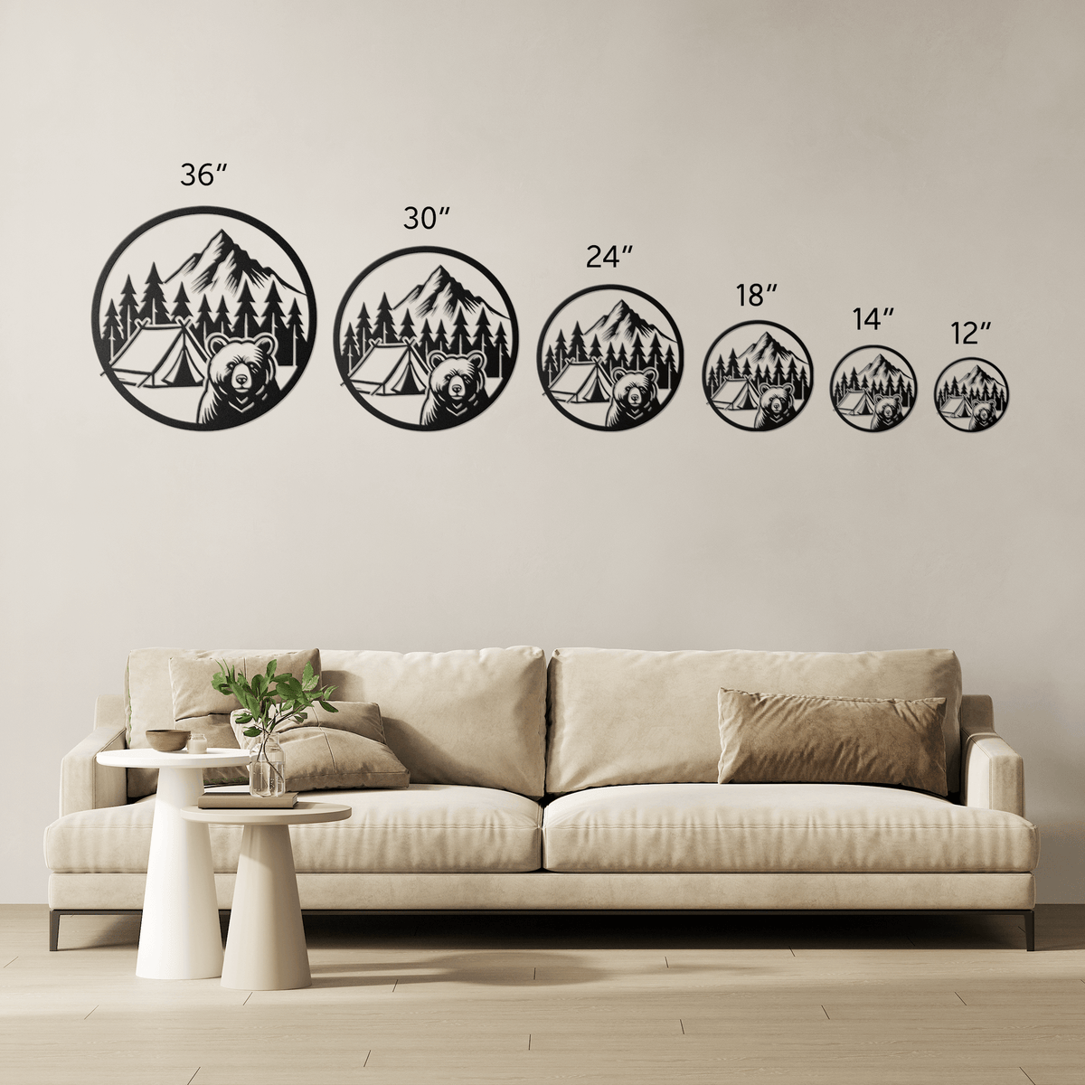 Metal wall art featuring bear camping scene in various sizes above beige sofa in living room