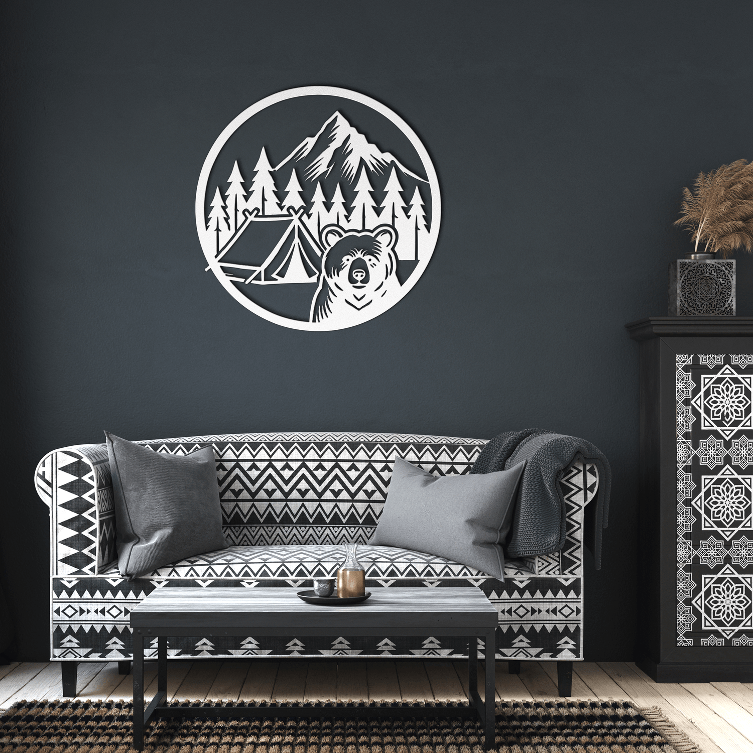 Bear camping metal wall art on dark wall above a patterned sofa, adding nature-themed decor to the living space.