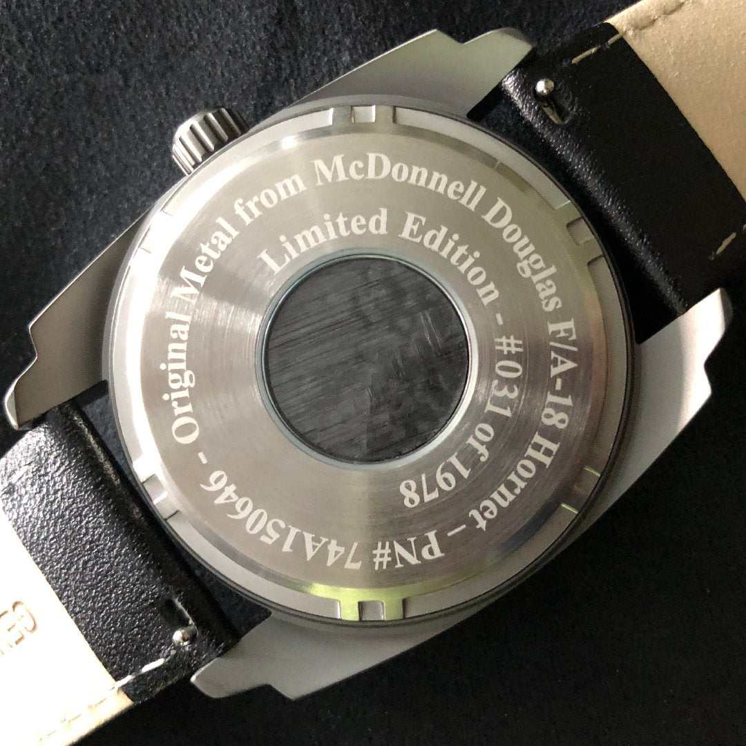 F-18 Hornet tribute watch case back with original McDonnell Douglas airframe metal and black leather band
