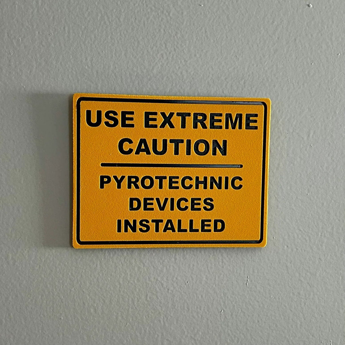 Pyrotechnic Devices Wall Sign with bold industrial warning, durable plastic, high-contrast lettering, easy mounting