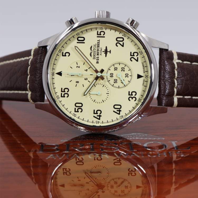 B-25 Mitchell tribute watch with polished stainless steel case, beige dial, and brown leather band with stitching