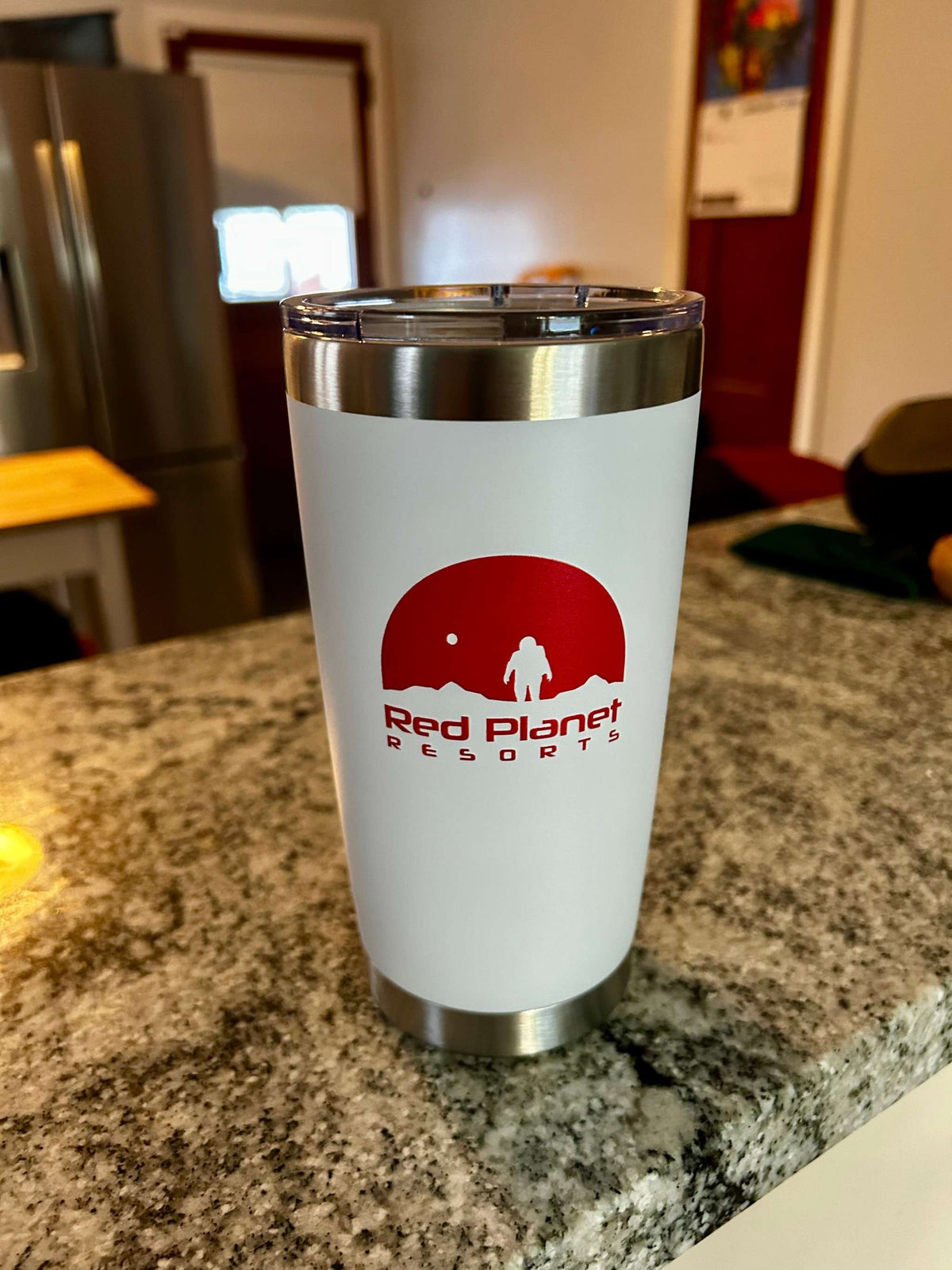White stainless steel rocket propellant tumbler with hazard markings and luxury Red Planet Resorts logo