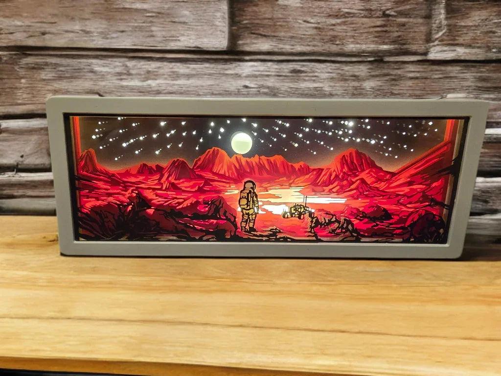 Walking on Mars 3D Paper Light showing laser-cut Martian exploration scene with warm LED glow
