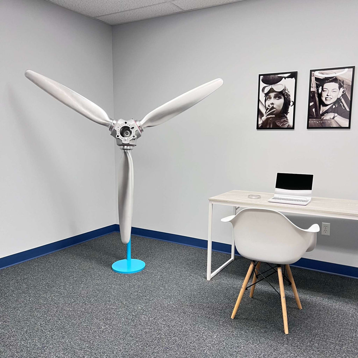 3-bladed McCauley aluminum airplane propeller with brushed finish and red snap rings wall display