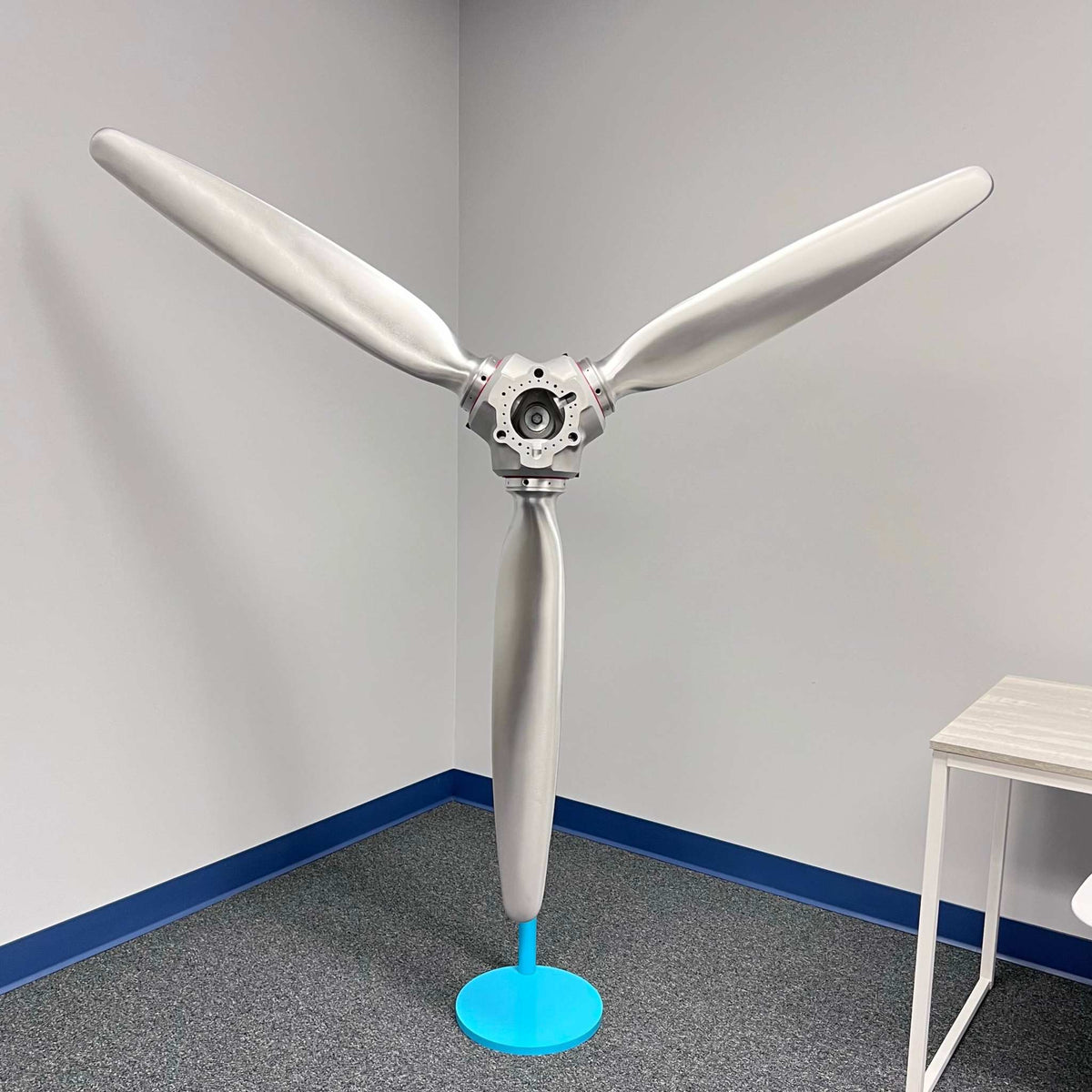 3-bladed McCauley aluminum airplane propeller with brushed finish and red snap rings wall display