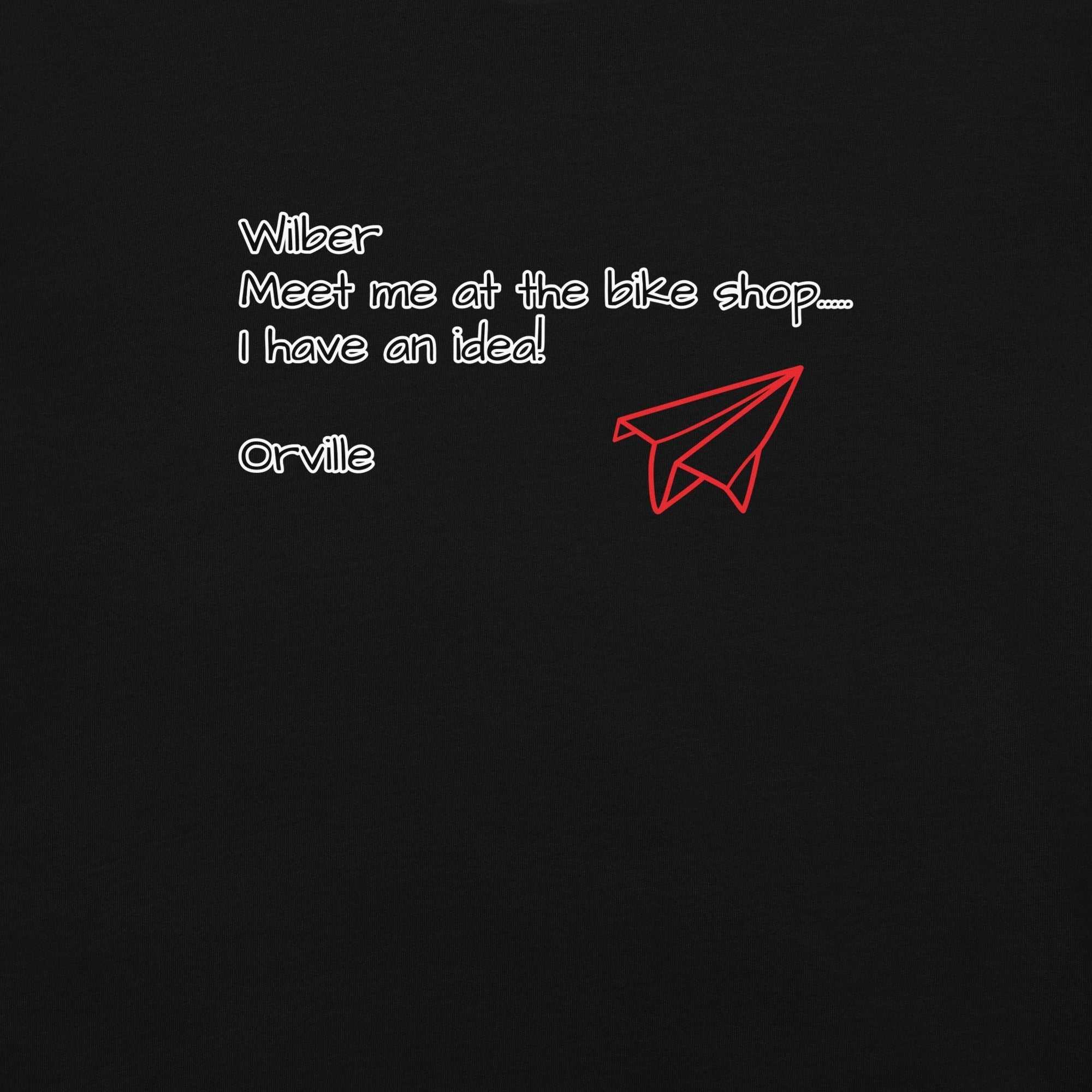 Bike Shop Wilbur black t-shirt with white text and red paper airplane graphic, 100% ring-spun cotton, heavyweight breathable fabric