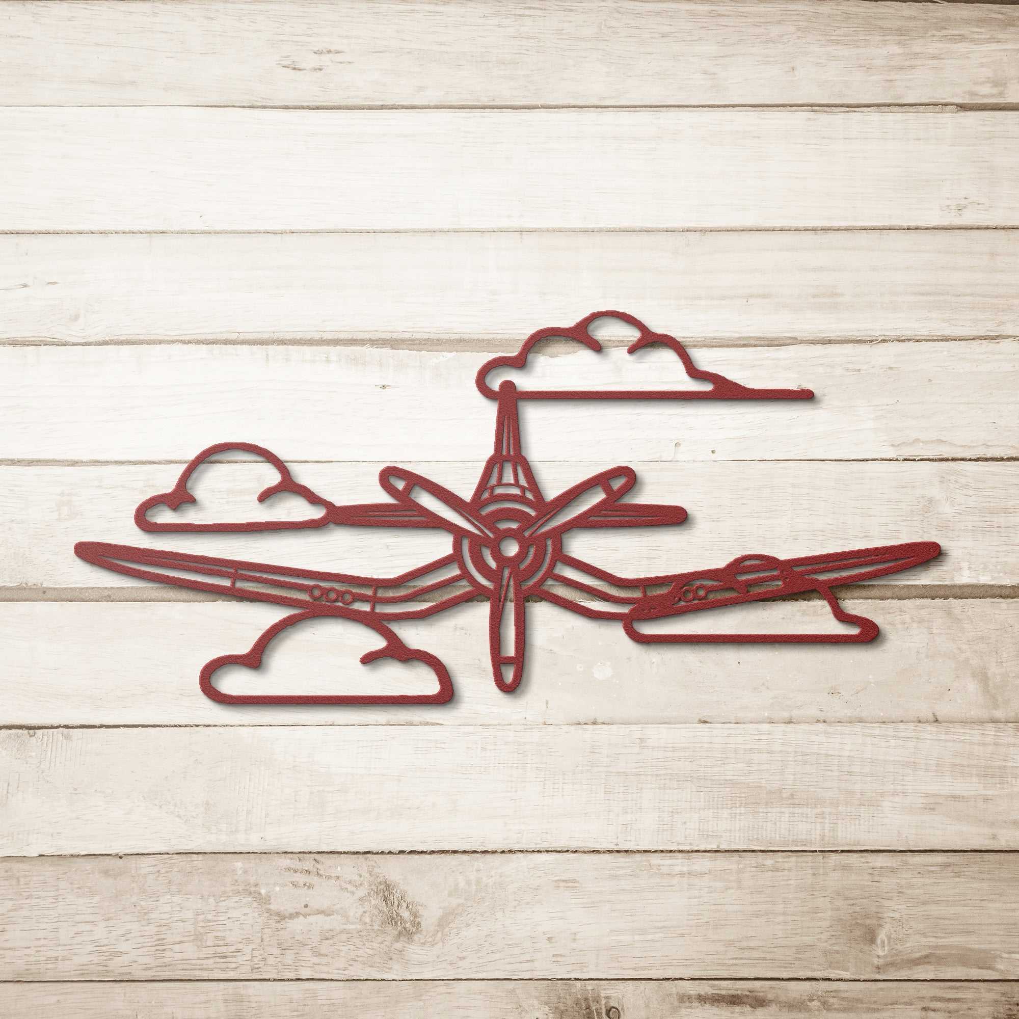 F4U Clouds WWII Corsair metal wall art in red steel silhouette with clouds mounted on wood wall