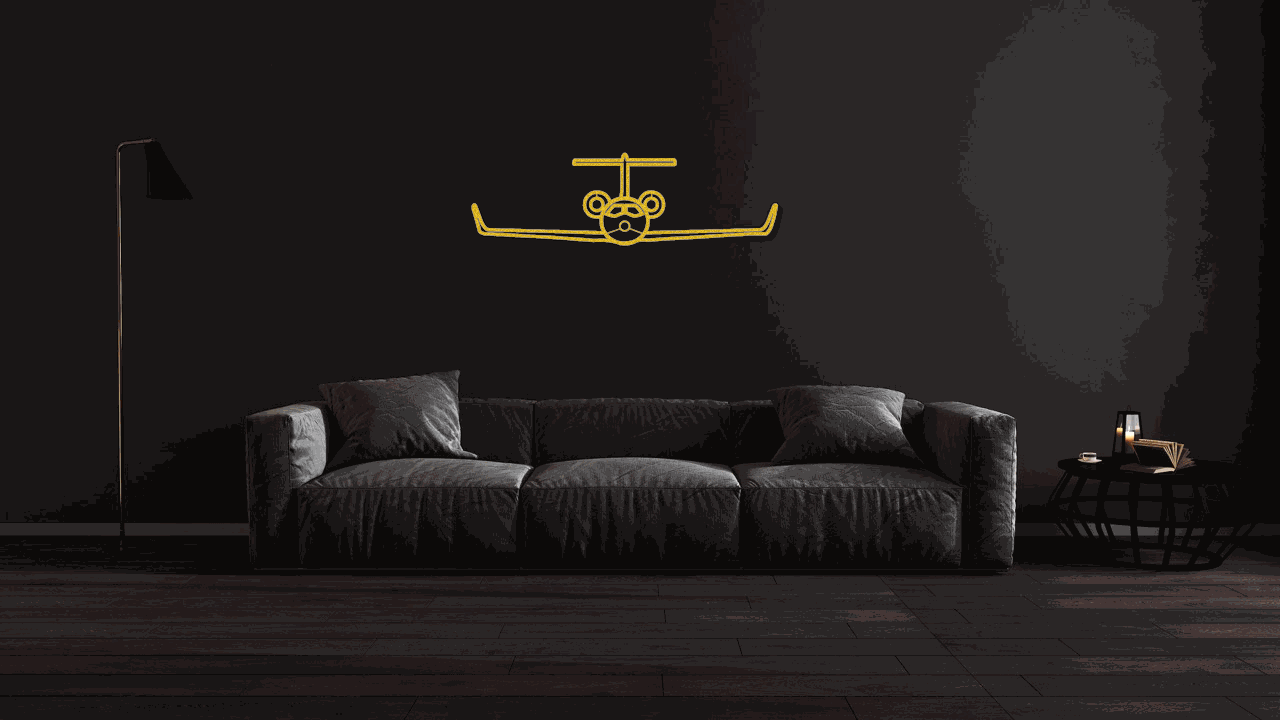 Metal wall art steel silhouette of an aviation jet in gold above a modern black sofa in a dark living room