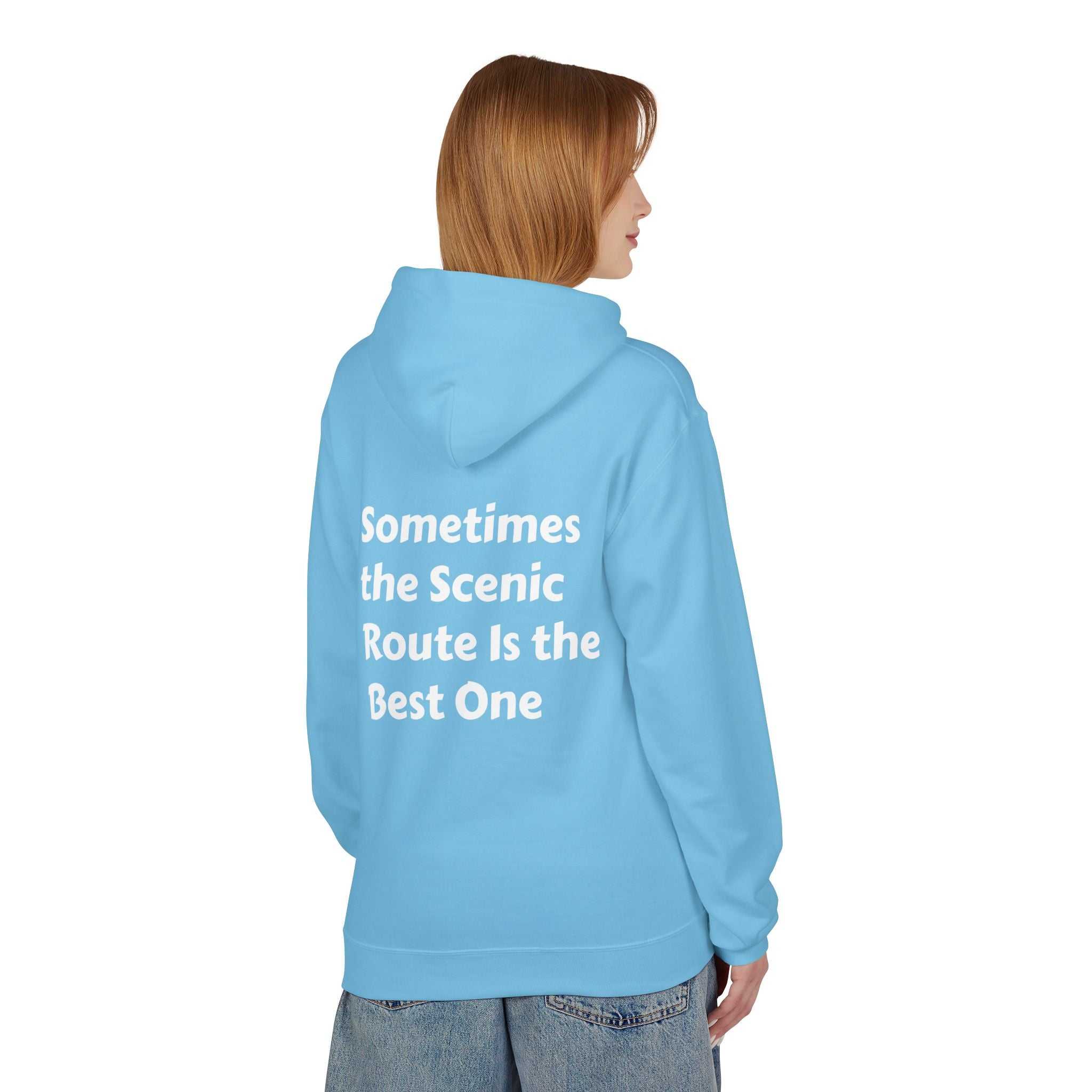 Light blue Inspirational travel hoodie with white scenic route quote on back, worn by model facing away