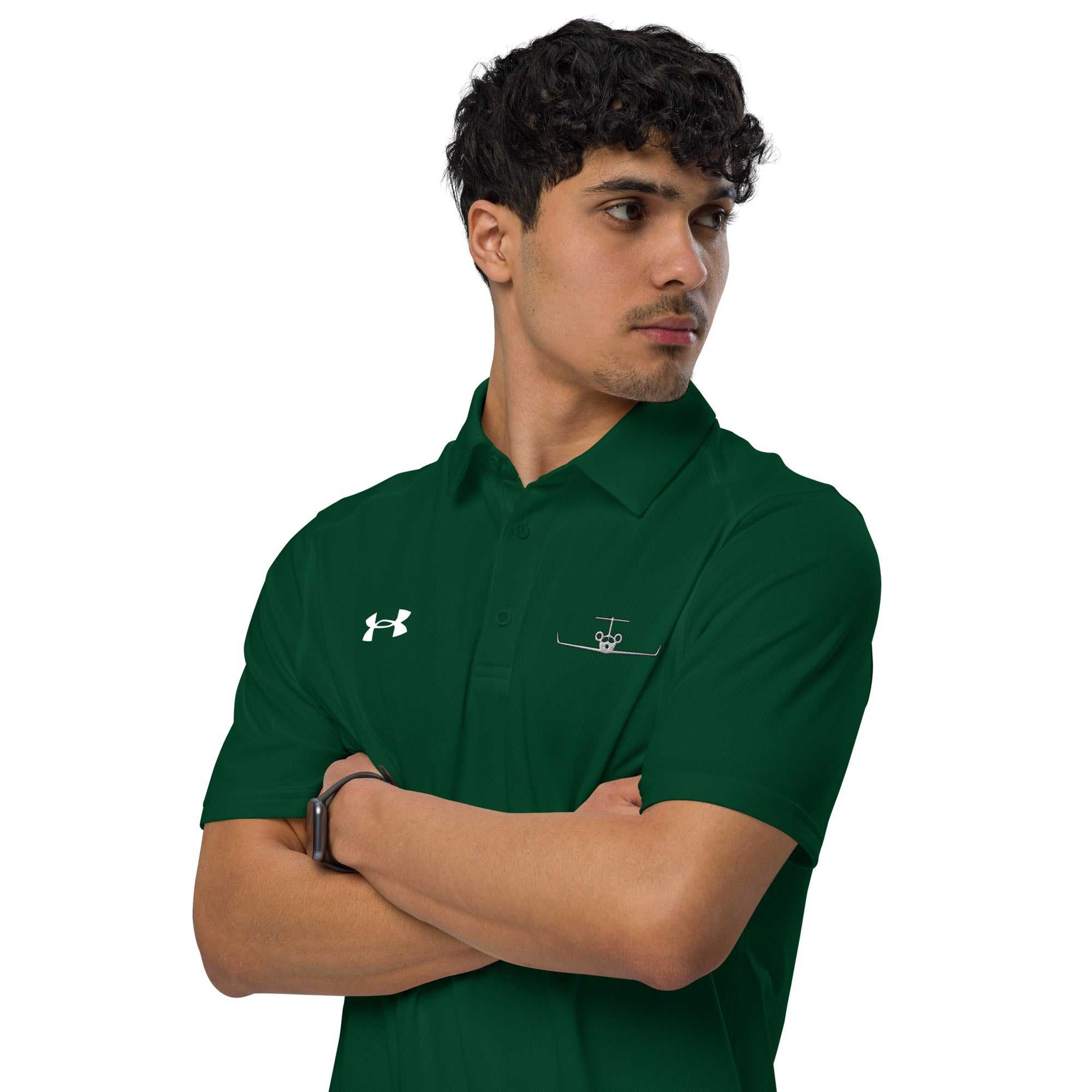 Man wearing green pilot polo shirt with embroidered private jet logo and Under Armour logo on chest