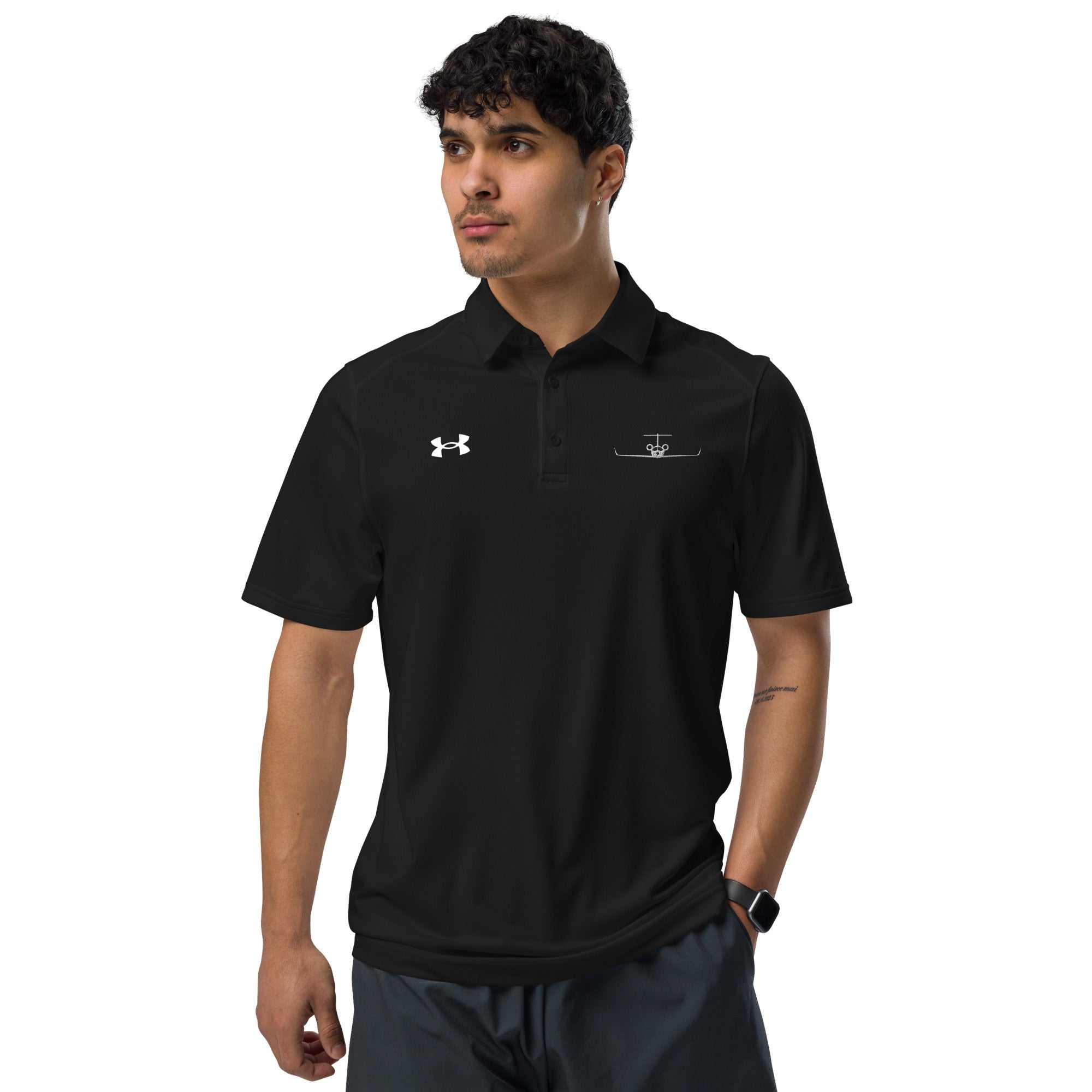 Man wearing black pilot polo shirt with embroidered private jet logo and Under Armour logo