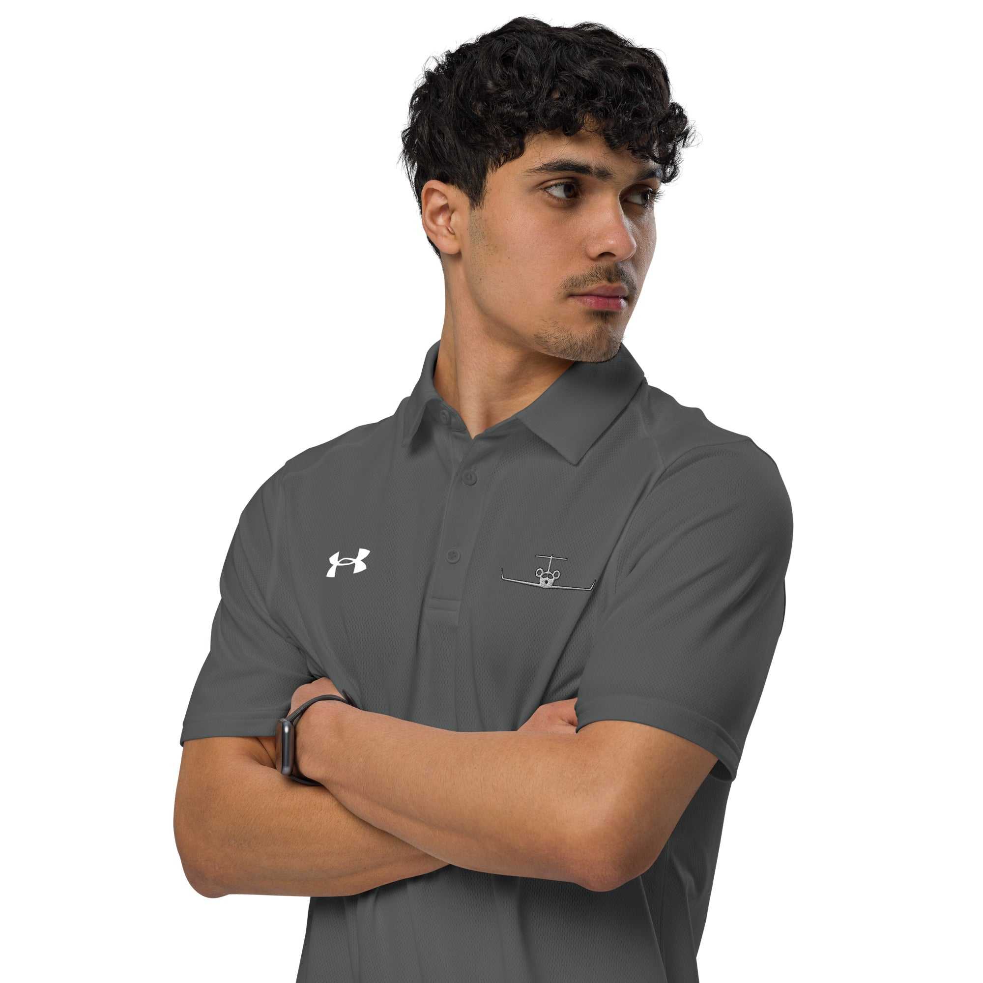Man wearing gray pilot polo shirt with embroidered private jet logo and Under Armour logo on chest