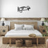 Vintage airplane metal wall art in black hanging above rustic wooden bed in cozy bedroom
