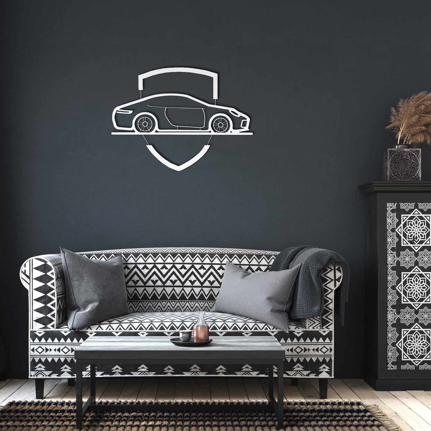 Elegant metal sign with car emblem mounted on dark wall above patterned sofa in modern living room