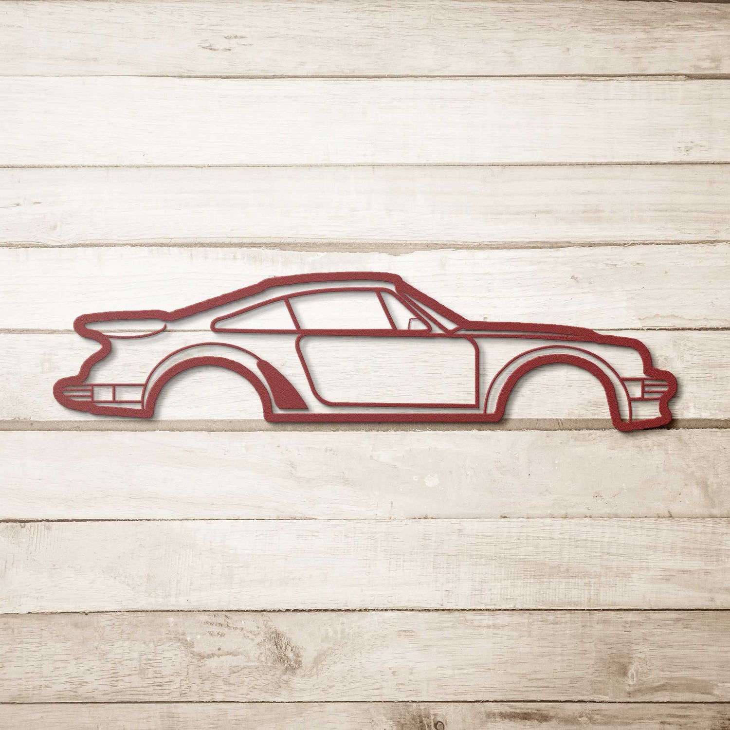 Metal Wall Art Nine Thirty Silhouette car design in red powder-coated steel on wooden background