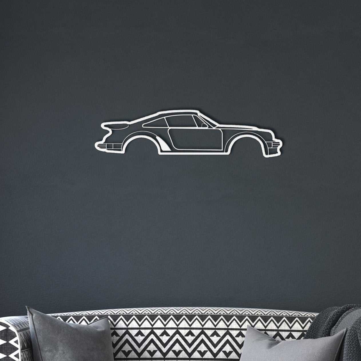 Minimalist metal wall art silhouette of a car in white powder-coated steel on dark wall