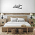 Elegant metal sign of private jet wall decor above wooden bed in modern bedroom