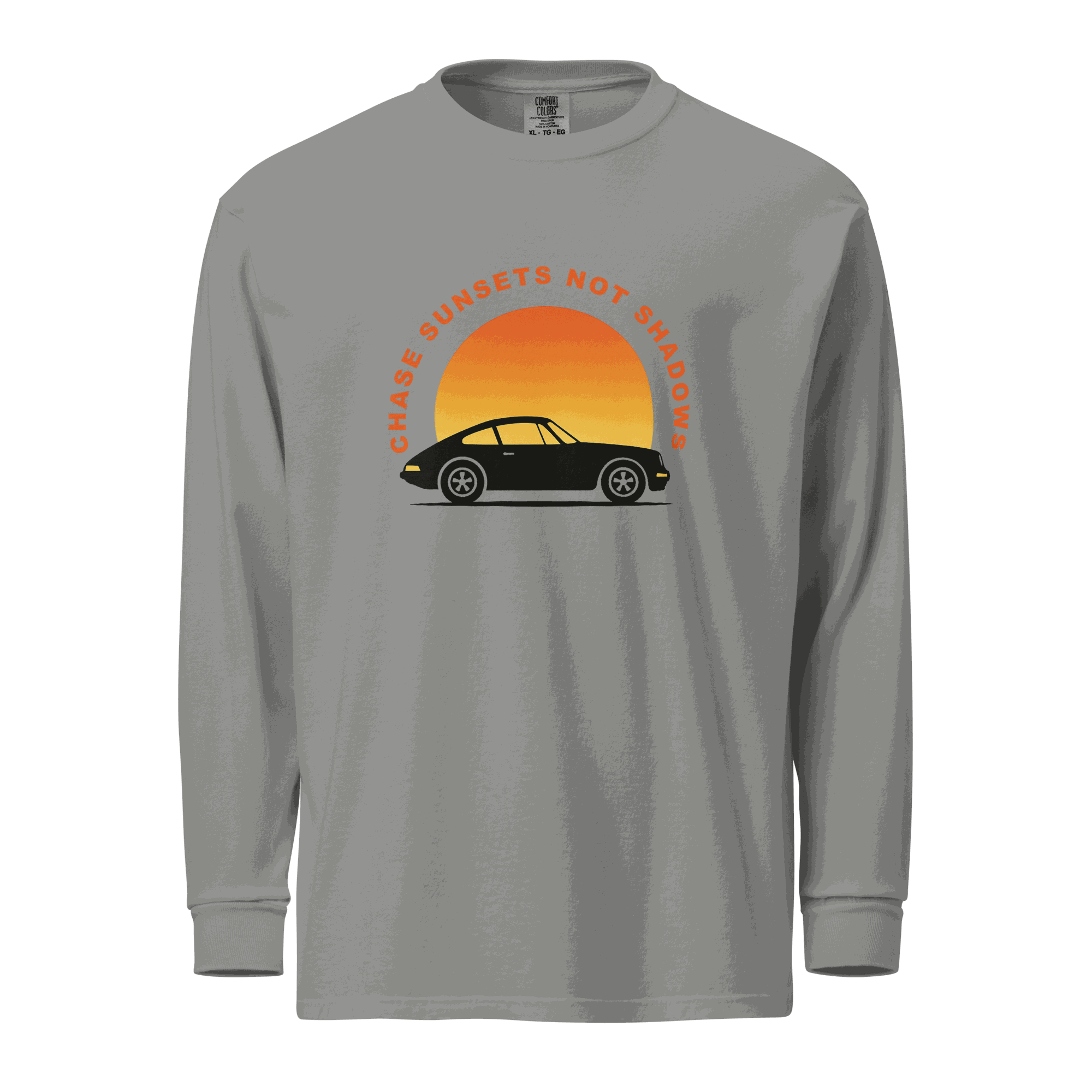 Gray garment-dyed long sleeve shirt with vintage car and sunset graphic and text "Chase sunsets not shadows"