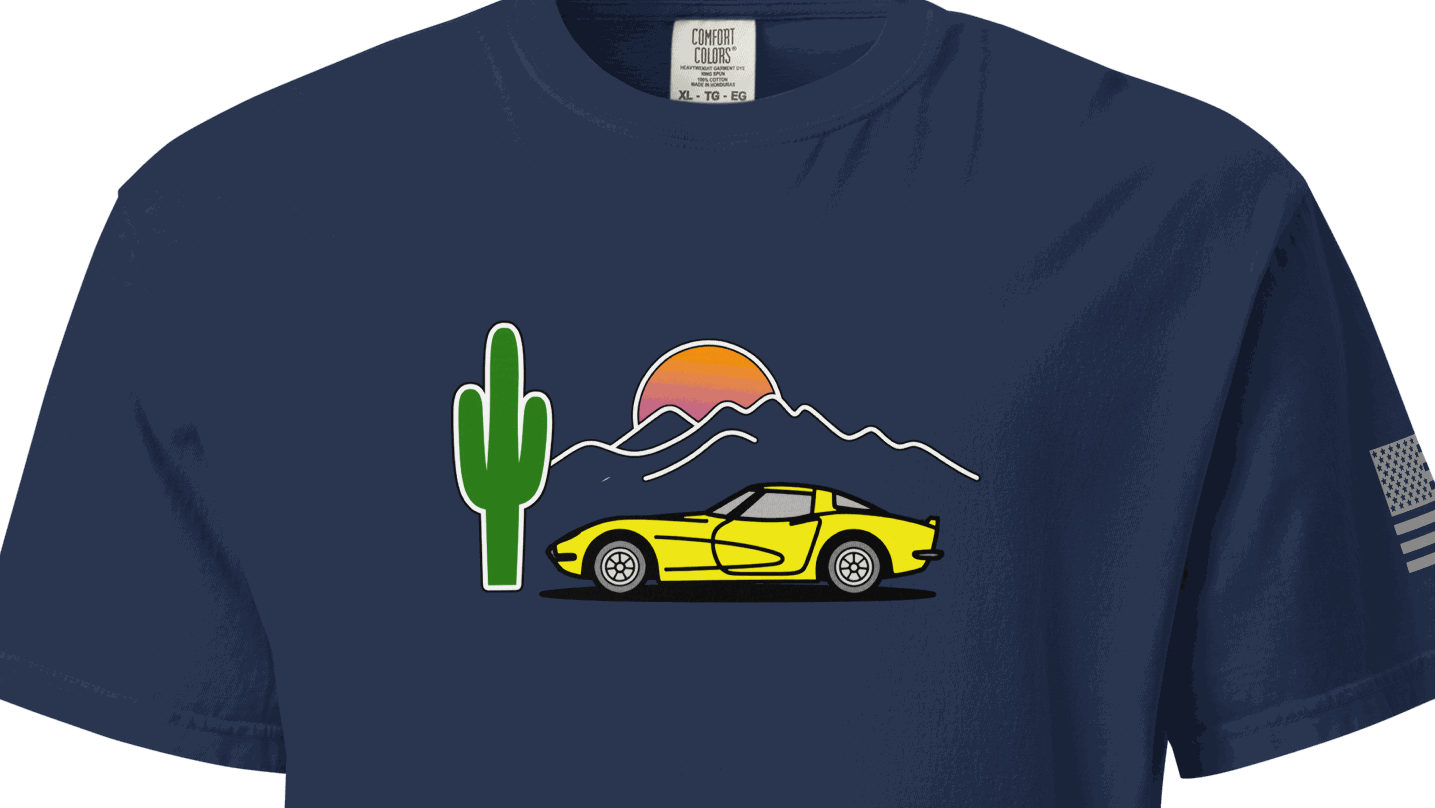 Navy blue t-shirt with a graphic of a yellow car, cactus, and sunset on a black background