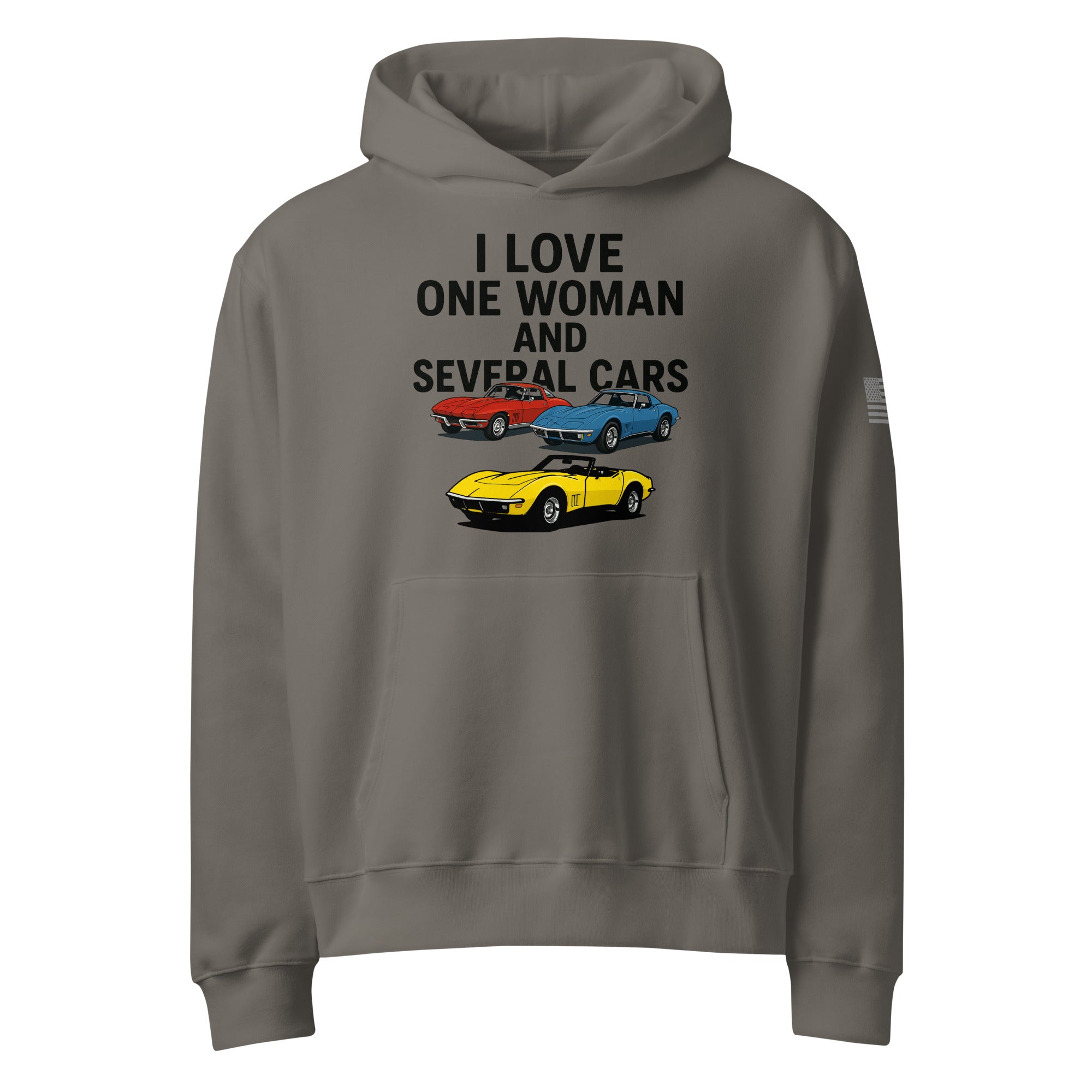 oversized heavyweight hoodie with ‘One Woman Several Cars’ text printed on the front — features a soft brushed fleece interior, double-layered hood without drawcords, front kangaroo pocket, and a roomy unisex fit — displayed in multiple color options.”