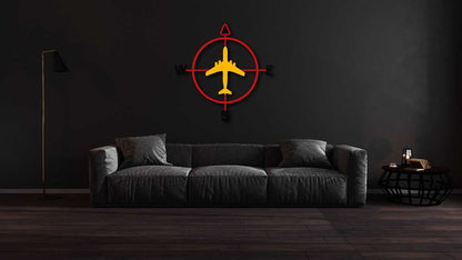 Aviation compass metal wall art with airplane design in red and yellow, indoor outdoor decor above gray sofa