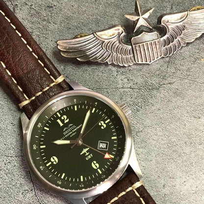 B-17 Tribute watch with stainless brush finish, dark green dial, and brown leather band with stitching