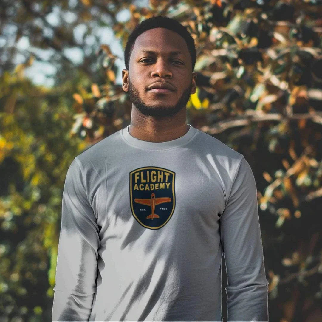 man wearing gray Flight Academy long sleeve t-shirt with logo outdoors