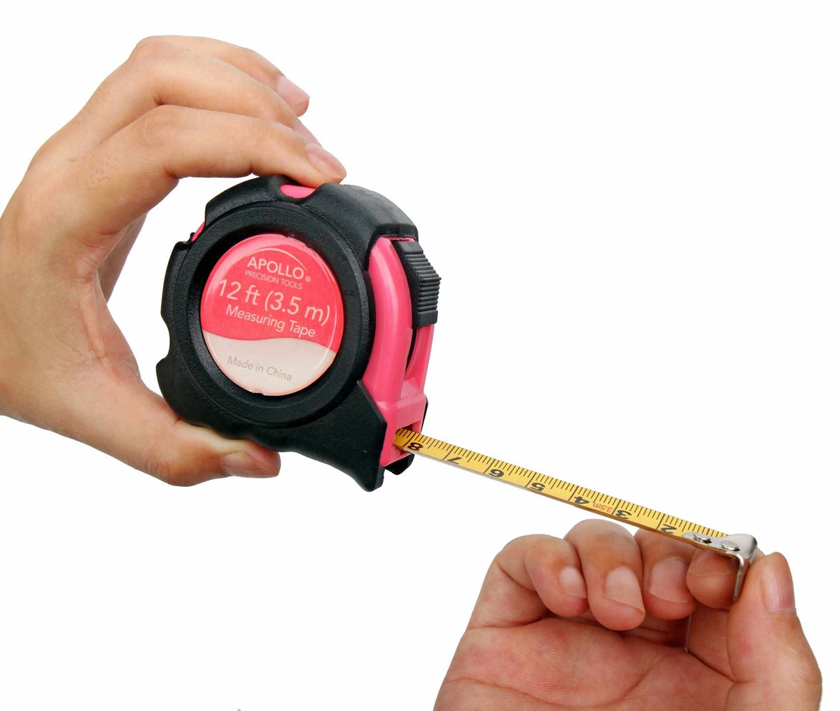Hands holding a pink and black 12 ft measuring tape from the 39 Piece General Tool Set by Apollo Tools