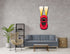 Red metal car wall art with headlights mounted on living room wall above gray sofa.
