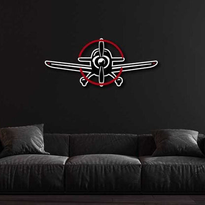 Multicolor metal sign featuring a propeller plane design mounted on a black wall above a dark gray sofa.