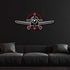 Multicolor metal sign featuring a propeller plane design mounted on a black wall above a dark gray sofa.