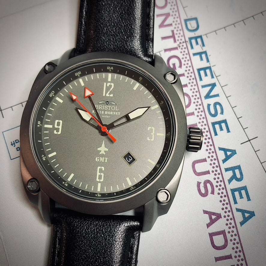 F-18 Hornet tribute watch with gun metal finish, gray dial, black leather strap, and Swiss quartz movement