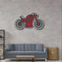 Red and black motorcycle metal wall art mounted above a gray sofa in a modern living room