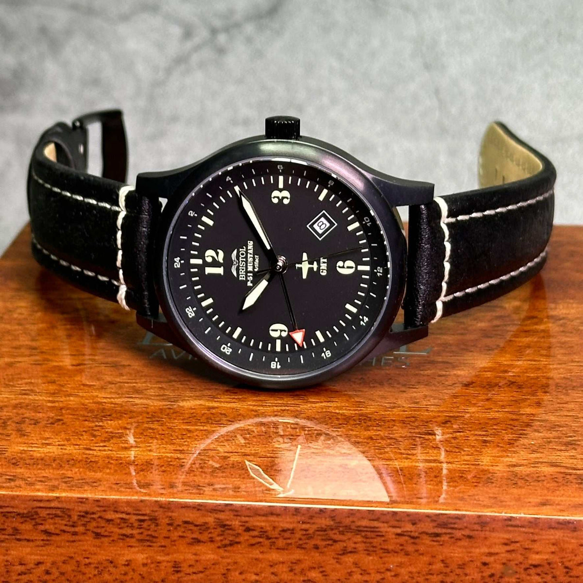 P-51 Mustang tribute watch with black dial, black leather band, Swiss quartz movement, and scratch-resistant sapphire crystal