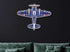 Multicolor aviation metal wall art in classic plane design mounted on dark wall above green sofa