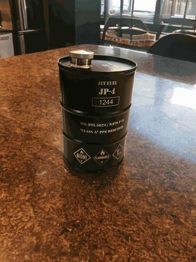 JP-4 Jet Fuel Flask shaped like vintage fuel barrel with hazard markings and screw cap on countertop