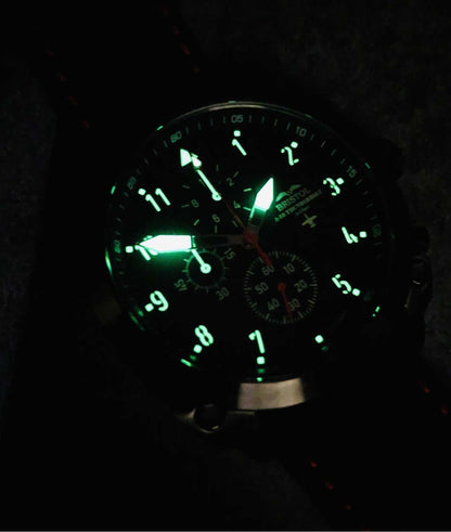 A-10 Thunderbolt watch with glowing Super Luminova dial and black leather band in low light