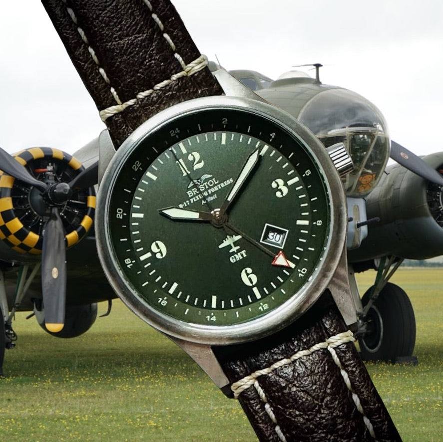B-17 Tribute watch with stainless brush finish, dark green dial, and brown leather band featuring B-17 airframe artifact