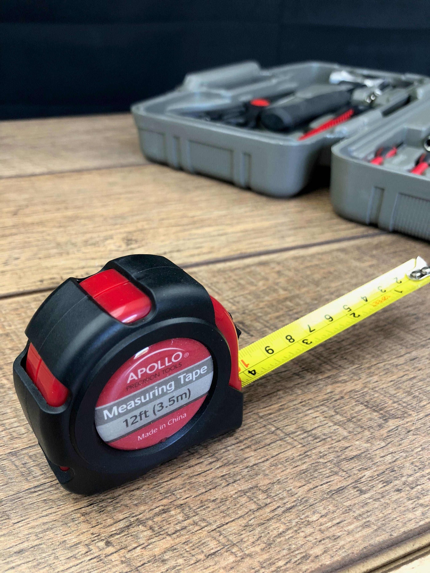 Compact Apollo General Tool Set with measuring tape and organized tools in case on wooden surface