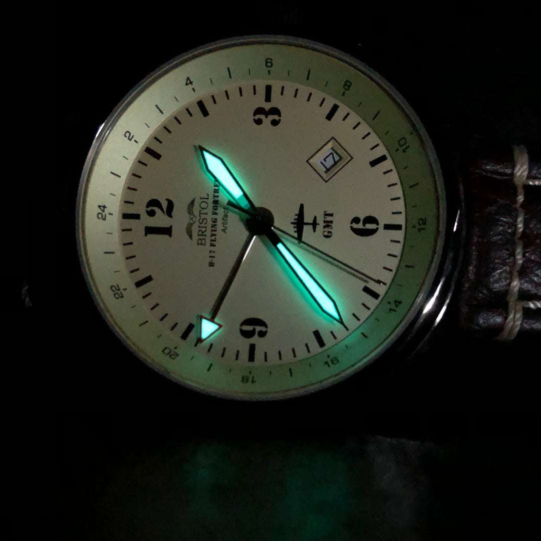 B-17 Flying Fortress tribute watch with beige dial, luminescent hands, polished stainless steel case, and brown leather strap with stitching