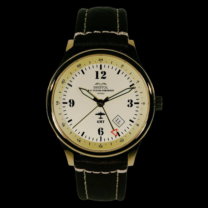 B-17 Tribute watch with gold finish, beige dial, stainless steel case, brown leather strap, and original B-17 Flying Fortress airframe artifact display