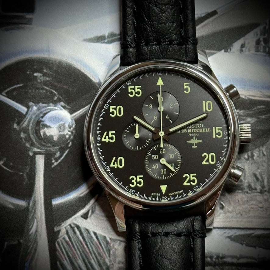 B-25 pilot watch with black leather band and polished stainless steel case inspired by B-25 Mitchell bomber history